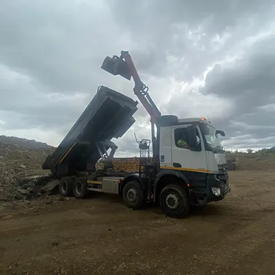 A dump truck with a crane on the back of it.