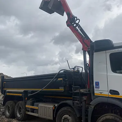 A white truck with a crane on top of it.