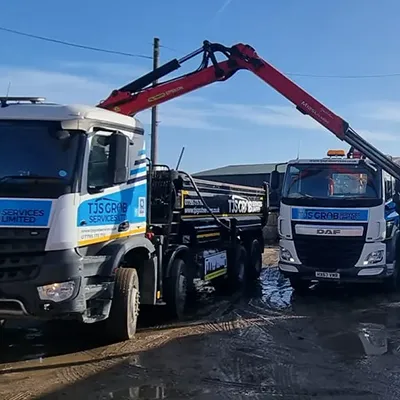 A tow truck with a crane on the back of it.