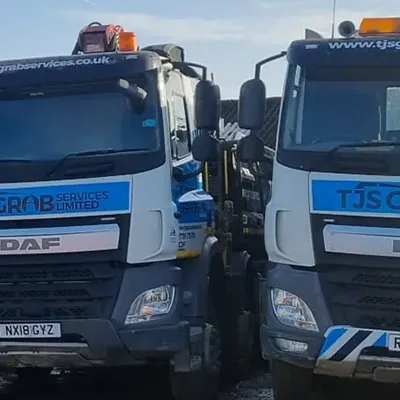 A couple of trucks parked next to each other.