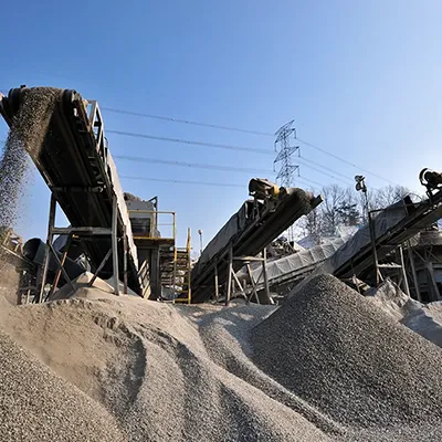 A large pile of sand sitting next to a pile of dirt.